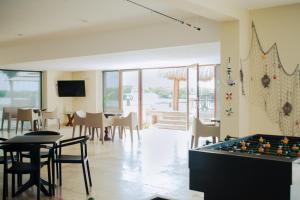a living room with a pool table and chairs at Villas Grand Marina Kinuh in Telchac Puerto