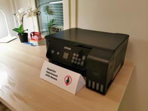 a black printer sitting on top of a table at Oulu Hotelli Apartments in Oulu