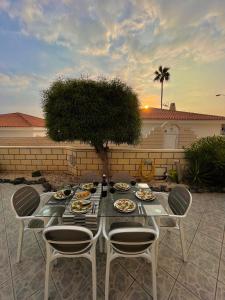 a table with plates of food on a patio at Villa Erna Relax Dream Holiday in Callao Salvaje