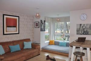 a living room with a couch and a table at LuxApartment - Port Of Leith - Free Parking in Edinburgh