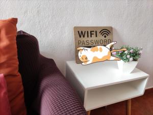 a bedside table with a dog pillow and a sign on it at Casa del Cu bano B- Biosphere Reserve in Santa Cruz de Tenerife