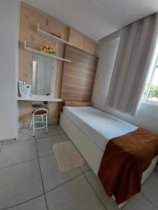 a small bedroom with a bed and a window at Villa Tata Suítes Ltda in Curitiba