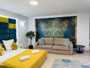 a bedroom with a large bed and a couch at Inna Strefa - Sleep & Restaurant in Inowrocław
