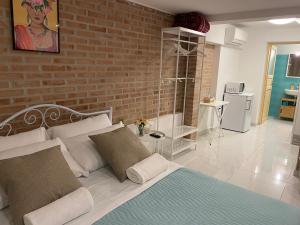 a bedroom with a bed and a brick wall at LAGUNA BLU Monolocale in Chioggia