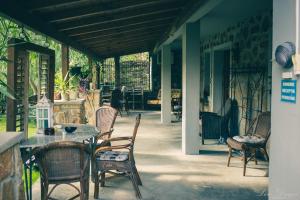 a patio with chairs and a table on a porch at Pensiunea Dulce Ambient in Păuliş