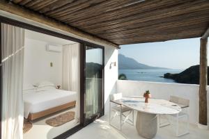 a bedroom with a bed and a table on a balcony at Miradouro de São Sebastião in São Sebastião