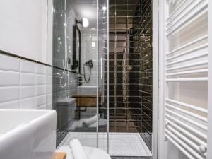 a glass shower in a bathroom with a toilet at limehome Madrid Calle de la Madera - Digital Access in Madrid