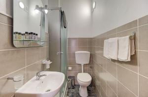 a bathroom with a sink and a toilet and a mirror at Lagoas in Tavira +74 photos