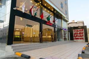 a man standing in front of a store window at Lambert ApartHotel in Jeddah