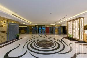 a lobby with a spiral design on the floor at Lambert ApartHotel in Jeddah