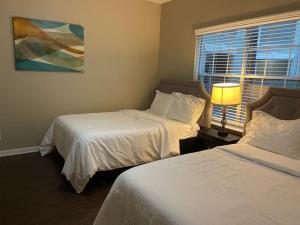 a hotel room with two beds and a window at Resort Style Apt/Home in Houston Medical Centre in Houston