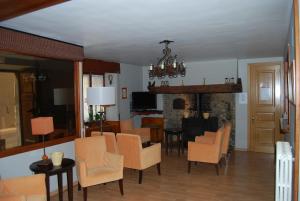 a living room with chairs and a dining room at Pension Casa Vicenta in Vielha