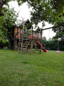 a playground with a tree house and a frisbee at Kumaczówka Mazury in Ruciane-Nida