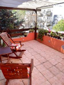 a patio with two chairs and an umbrella at Pocitos Nuevo in Montevideo