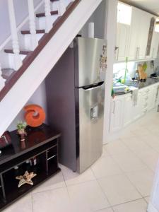 a kitchen with a stainless steel refrigerator next to a staircase at Pocitos Nuevo in Montevideo