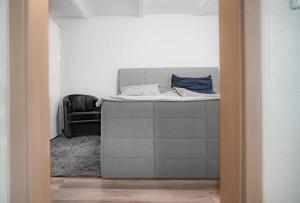 a bedroom with a bed and a chair at Düsseldorfer Apartment am See in Düsseldorf
