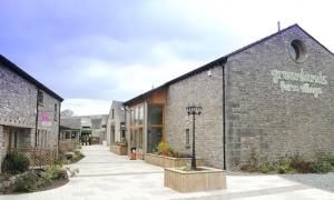 a brick building with a sign on the side of it at 4 Bed Luxury Lodge with Hot tub near Lake District in Warton