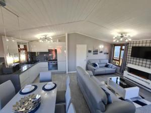 a living room with a couch and a table at 4 Bed Luxury Lodge with Hot tub near Lake District in Warton