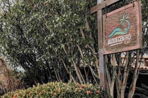 a sign for the bluing institution in front of trees at Búzios Centro Hotel in Búzios