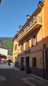 a building with a balcony on the side of it at Pension Casa Vicenta in Vielha