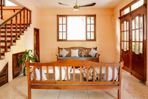 a living room filled with furniture and a large window at Casona Puerto Dreams in Puerto Escondido