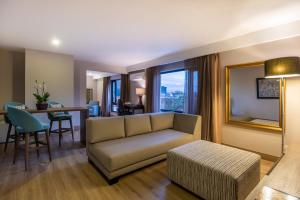 a living room with a couch and a table at Hotel Morrison Zona Rosa in Bogotá