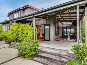 a house with a wooden porch with a deck at Havelock Haven - Havelock North Holiday Home in Havelock North