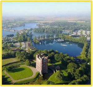 an aerial view of a castle and a lake at The Luxury break Sleeps 6 at 44 Kingfisher Court South facing in Tattershall