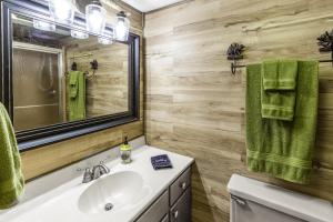 a bathroom with a sink and a mirror at The Treehouse in Franklin +26 photos