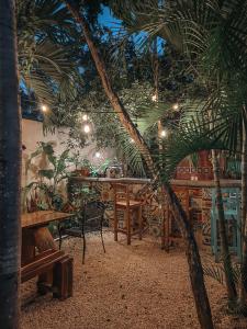 a restaurant with a table and a palm tree at Trece Lunas in Tulum