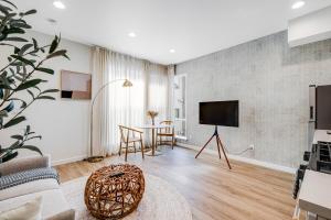 a living room with a table and a tv at Capitol Hill Rooftop R & R in Seattle