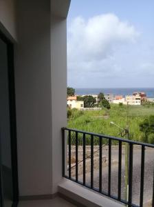 a balcony with a view of a field of grass at Luz d'Sol - Residencial Familiar in Pombas