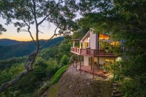 a house on the side of a hill with trees at Eagles Nest in Bryson City