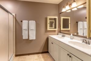 a bathroom with two sinks and a large mirror at Eagles Nest in Bryson City +22 photos