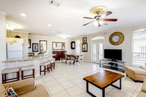 a living room with a bar and a dining room at Emerald Shores Cottage in Destin