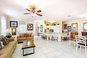 a living room with a couch and a table at Emerald Shores Cottage in Destin