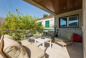 a patio with a couch and a table at Sweet Home Braga Hostel & Guest House in Braga