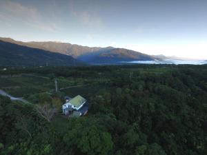 an aerial view of a house in the middle of a forest at Sao Ba Ding Homestay in Ruisui