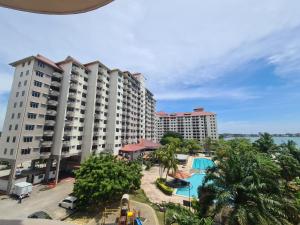 an aerial view of a resort with a swimming pool at Glory Beach Resort Seaview Private 2BR in Port Dickson