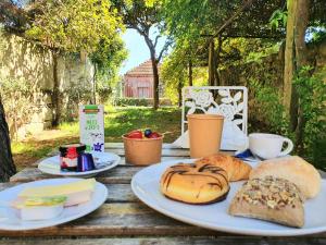 a table with plates of bread and pastries on it at Porto Alegria Garden in Porto