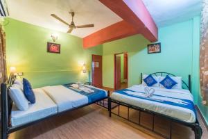 Postel nebo postele na pokoji v ubytování Kiara Hotel Goa