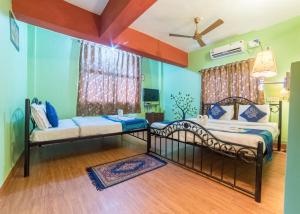 Postel nebo postele na pokoji v ubytování Kiara Hotel Goa