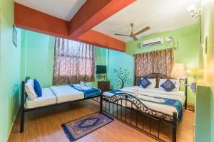 Postel nebo postele na pokoji v ubytování Kiara Hotel Goa