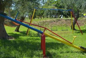 a group of playground equipment in a park at Othonas Apartments in Sidari