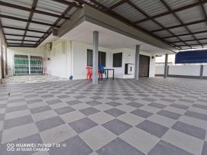 ein leerer Raum mit Schachbrettmuster in einem Gebäude in der Unterkunft SingLeisure Holiday House in Mersing