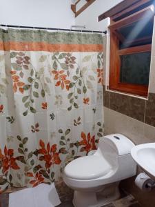 a bathroom with a toilet and a shower curtain at Casa Hotel La Villa del Rosario in Villa de Leyva