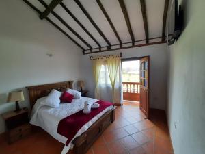 1 dormitorio con cama y ventana grande en Casa Hotel La Villa del Rosario, en Villa de Leyva