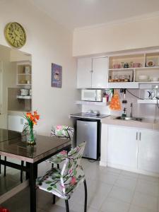 a kitchen with a table and a dining room at Evelyn's Place at Tagaytay 2 in Tagaytay