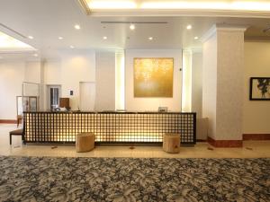 a lobby with a reception desk in a building at Chisun Grand Takayama in Takayama