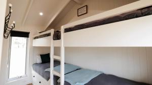 a bedroom with two bunk beds and a window at Wallinga Farmstay Mudgee in Mudgee